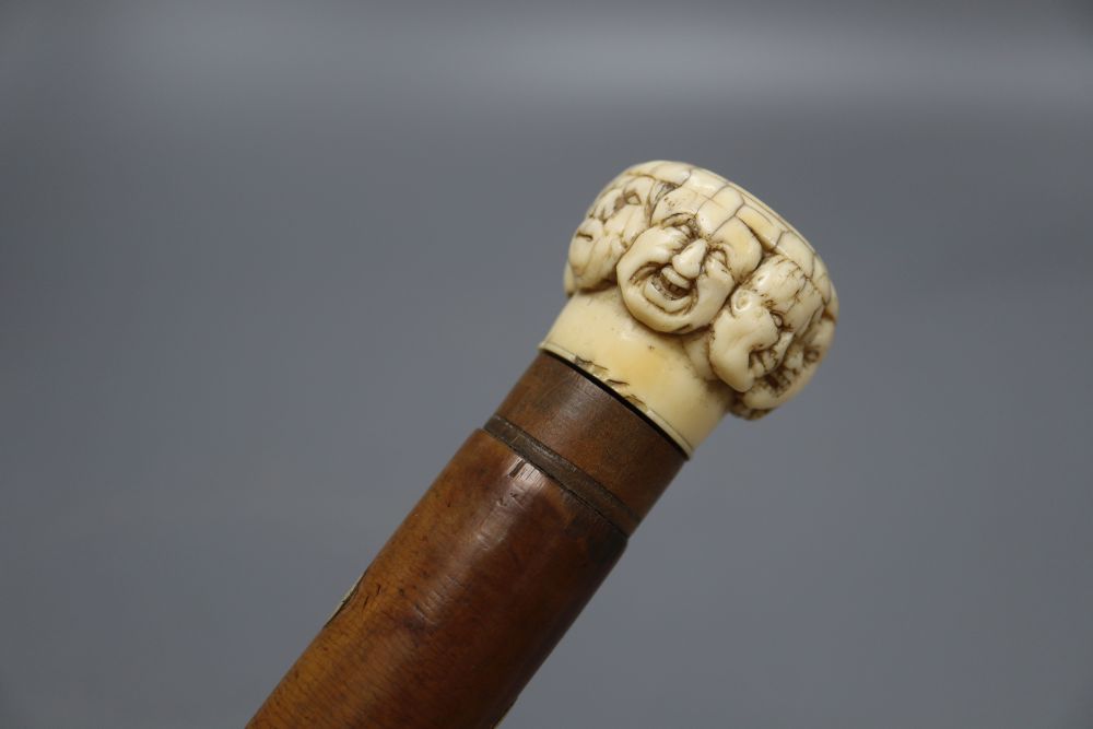 A late 19th century ivory mask handled walking cane, overall length 92cm